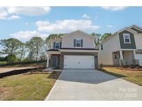 Charming two-story home featuring a two-car garage, brick accents, and blue shutters at 1466 31St Ne St, Conover, NC 28613
