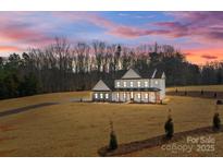 Beautiful two-story modern farmhouse-style home with a landscaped front yard and inviting front porch at 1695 Agner Rd, Salisbury, NC 28146