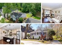 Charming home with fresh exterior, mature trees and landscaping, and covered entrance steps at 3016 Hanson Dr, Charlotte, NC 28207