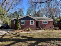 Charming brick ranch-style home with manicured front yard and lush landscaping, located in a quiet neighborhood at 3321 Auburn Ave, Charlotte, NC 28209