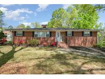 Charming brick home with landscaped front yard and inviting entrance, perfect for curb appeal at 401 Dakota St, Kannapolis, NC 28083