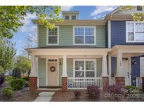 Charming two-story home with a welcoming front porch, white pillars, and a well-maintained lawn at 464 Hurston Cir, Charlotte, NC 28208