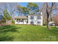 Charming home with a well-manicured lawn and beautifully landscaped front yard at 6245 Wheeler Dr, Charlotte, NC 28211