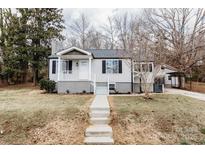 Charming single-story home with a welcoming front porch and a well-maintained yard and a carport at 634 Mckee St, Albemarle, NC 28001