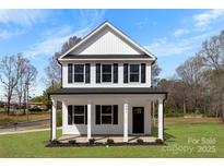 Charming two-story home with white siding, black shutters, and a welcoming front porch at 771 E Maurice St, Monroe, NC 28112