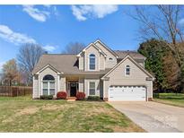 Charming two-story home with a well-manicured lawn and attached two-car garage at 123 Southhaven Dr, Mooresville, NC 28117