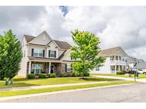 Charming two-story home with stone accents, manicured lawn and beautiful curb appeal at 128 Millen Dr, Mooresville, NC 28115