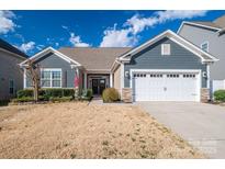 Charming home featuring a two-car garage, manicured lawn, and inviting front porch, creating great curb appeal at 138 Margo Ln, Statesville, NC 28677