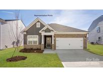 Charming single Gathering home featuring a two-car garage, stone accents, and manicured lawn at 2315 Riggs Rd, Sherrills Ford, NC 28673