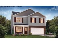 Two-story home featuring gray siding, brick accents, a two-car garage, and a welcoming front porch at 2319 Riggs Rd, Sherrills Ford, NC 28673