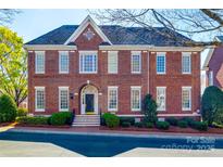 Charming brick home featuring multi-pane windows, elegant arched entryway, and manicured landscaping at 2622 Sheffield Crescent Ct, Charlotte, NC 28226