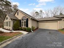 Charming home with stone accents, a well-maintained yard, and an attached garage at 2905 Polo View Ln, Matthews, NC 28105
