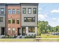 Charming townhome with a combination of brick and gray siding, complemented by lush landscaping at 403 Old Town Village Rd, Waxhaw, NC 28173