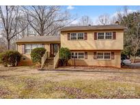 Charming two-story home with a brick and vinyl facade, complemented by well-maintained landscaping at 1142 Canterbury Dr, Lancaster, SC 29720