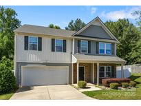 Charming two-story home with a well-manicured lawn and attached garage provides a welcoming and functional living space at 352 Nantucket Way, Rock Hill, SC 29732