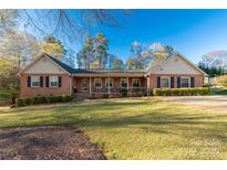 Charming brick home with a welcoming front porch and well-manicured lawn at 363 Arrowood Ave, Lancaster, SC 29720