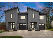 Modern townhome with gray exterior, stylish entry, and two-car garage creating a contemporary and inviting curb appeal at 431 Norris Ave, Charlotte, NC 28206