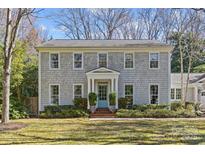 Charming exterior of a classic gray shingle home with a well-manicured lawn and inviting front entrance at 4501 Mullens Ford Rd, Charlotte, NC 28226