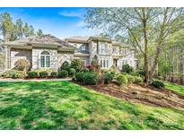 Stunning home with manicured lawn and mature trees providing shade and curb appeal at 7509 Webbs Chapel Cove Ct, Denver, NC 28037