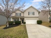 Charming two-story home with a well-maintained front yard and a two-car garage at 9037 Pembroke Ct, Fort Mill, SC 29707