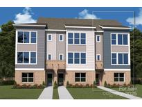 New townhome design with brick accents, a well-manicured lawn, and large windows at 1417 Lithium Ln, Charlotte, NC 28211
