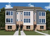 Modern townhome showcases clean lines and large windows that allow natural light to fill the living spaces at 1425 Lithium Ln, Charlotte, NC 28211