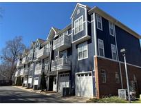Beautiful townhome row showcasing private balconies and attached garages at 1634 Walnut View Dr, Charlotte, NC 28208