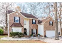 Charming two-story brick home with black shutters and well-maintained landscaping at 2426 Tory Oak Pl, Matthews, NC 28105