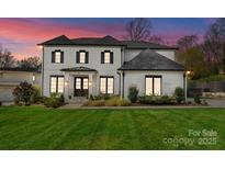 Stunning two-story home featuring a manicured lawn, dark window trim and a brick facade at 300 Mammoth Oaks Dr, Charlotte, NC 28270