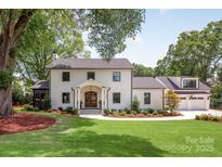 Stunning two-story home featuring a manicured lawn, double door entry, and a charming facade at 401 Woodland St, Davidson, NC 28036