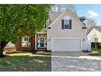 Charming two-story home with a well-manicured lawn and a two car garage at 4130 Brownwood Nw Ln, Concord, NC 28027