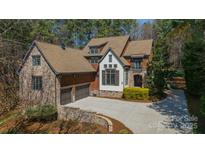 Beautiful two-story home featuring a stone and wood exterior, a two-car garage, and a well-maintained driveway at 492 Agnew Rd, Mooresville, NC 28117