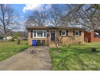Charming brick home with a well-maintained lawn and inviting front entrance at 519 Locust St, Rock Hill, SC 29730