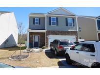 Two-story home with stone accents, gray siding, and a well-maintained front lawn at 8112 Clairwood Dr, Charlotte, NC 28269