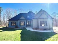 Beautiful single Gathering home with lush green lawn, side entry garage, and covered entryway at 825 Potneck Rd, Salisbury, NC 28147