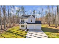 Two-story home with a 2 car garage, neutral siding, and a well manicured lawn at 126 Orville Rd, Statesville, NC 28677