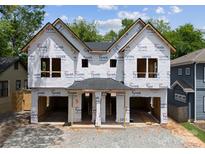 Exterior view of a new construction home, showcasing its framing and initial stages of completion at 1411 Downs Ave, Charlotte, NC 28205
