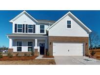 Charming two-story home featuring a brick facade, white siding, black shutters, and a two-car garage at 1829 Augustine St, Monroe, NC 28112