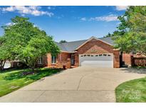 Charming brick home featuring an attached two-car garage and well-maintained landscaping at 1963 Wexford Ct, Gastonia, NC 28054