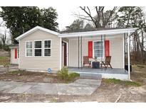 Charming single-story home with vinyl siding, front porch with seating, and red shutters at 2010 Simmons St, Gaston, NC 28052