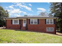 Charming brick home with manicured lawn and beautiful curb appeal at 219 Summit St, Norwood, NC 28128