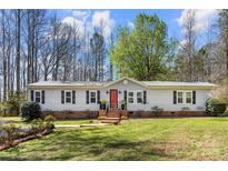 Charming single-story home with a brick foundation, red front door, black shutters, and a well-manicured lawn at 230 Valley View Dr, Clover, SC 29710