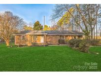 Charming brick home with a lush green lawn and mature trees in a quiet neighborhood at 2750 Morgan Rd, Gold Hill, NC 28071