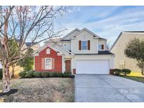 Charming two-story home featuring a brick facade, two-car garage, and well-maintained landscaping at 4513 Staffordshire Ln, Charlotte, NC 28213