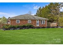 Charming brick home with a well-maintained lawn and mature landscaping at 5140 Old Monroe Rd, Indian Trail, NC 28079