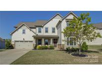 Charming two-story home featuring a neutral color palette, well-manicured lawn, and an attached two-car garage at 14229 Twin Eagles Ln, Charlotte, NC 28278
