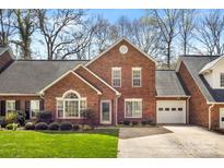 Charming brick home features an attached garage, well-maintained landscaping, and a traditional design at 176 Columns Cir, Shelby, NC 28150