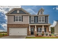 Charming two-story home featuring a brick facade, gray siding, and well-manicured lawn at 3021 Sassafras Trl, Gastonia, NC 28056