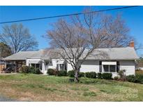 Charming single-story home featuring a well-maintained lawn and classic white siding and awning-covered windows at 403 E 27Th St, Kannapolis, NC 28083