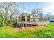 Backyard view of a home with decks and grassy area at 1001 Churchill Downs Ct # A, Charlotte, NC 28211